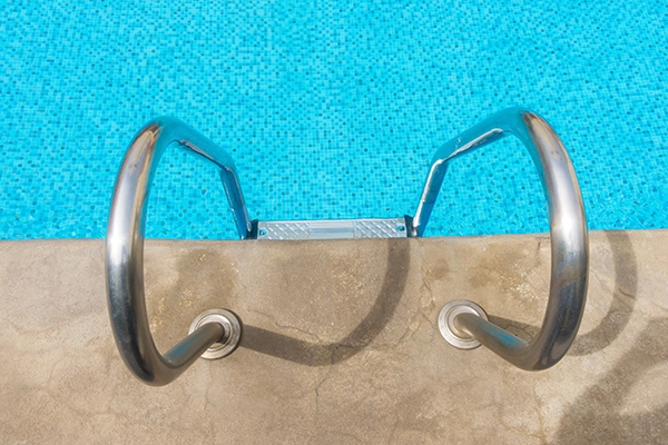 Equipamiento Piscina Valencia: escalera de acero inoxidable instalada en piscina.